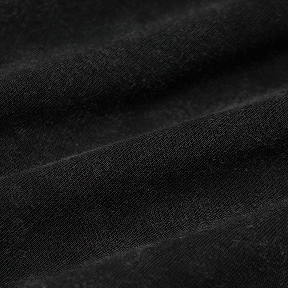 Close-up of soft black cotton fabric showcasing texture and depth, ideal for edgy punk rock fashion.