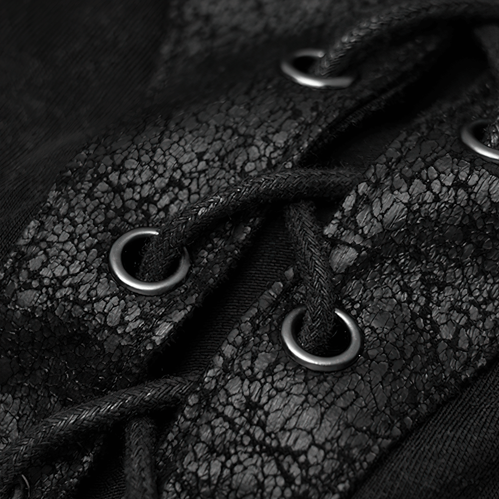 Close-up of edgy punk rock t-shirt showcasing leather-look lace-up detail and rope-style binding in black fabric.