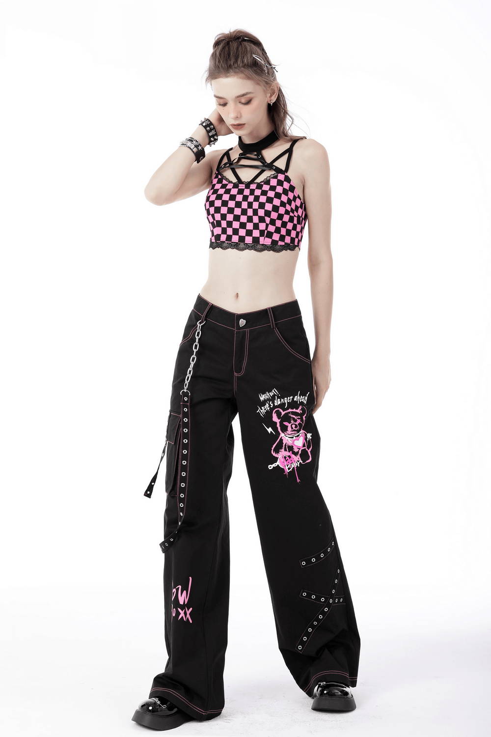 Edgy punk rock wide pants with chains, pink skull graphic, and stylish crop top, perfect for a rebel night out.