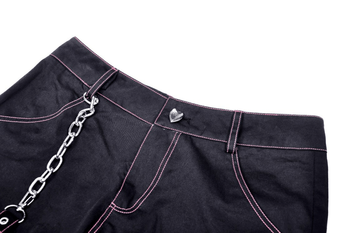 Close-up of edgy punk rock wide pants with chains and pink stitching, showcasing unique style and rebellious detail.