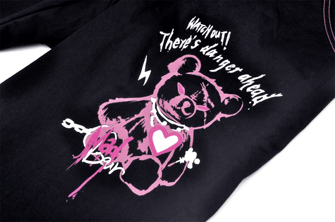 Edgy black top featuring a pink bear graphic with the text 'Watch out! There's danger ahead!' for a punk rock vibe.