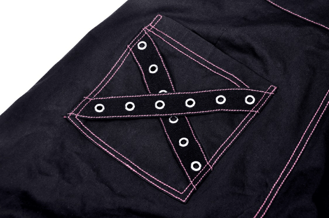 Close-up of edgy black punk rock pants pocket with pink stitching and grommet accents, showcasing unique gothic style.