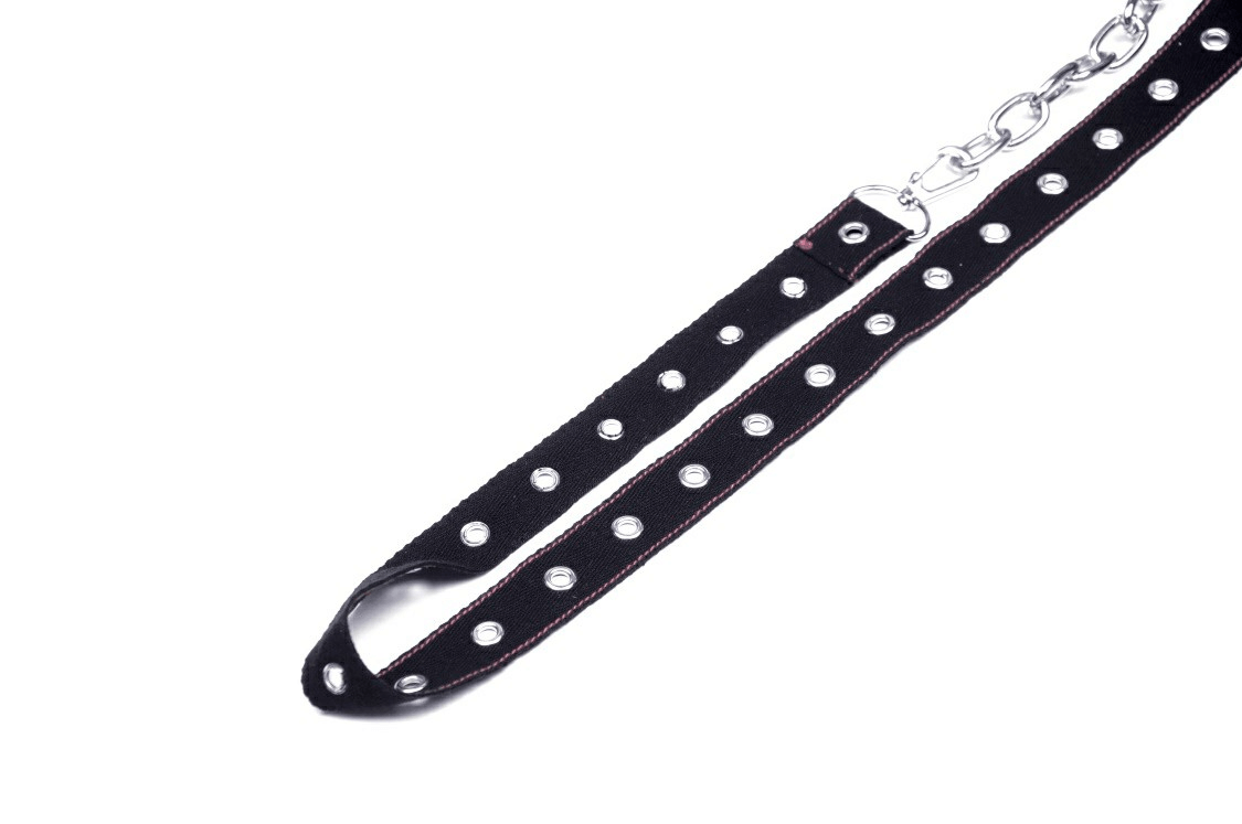 Edgy black fabric belt with silver studs and chain detailing for punk rock style.