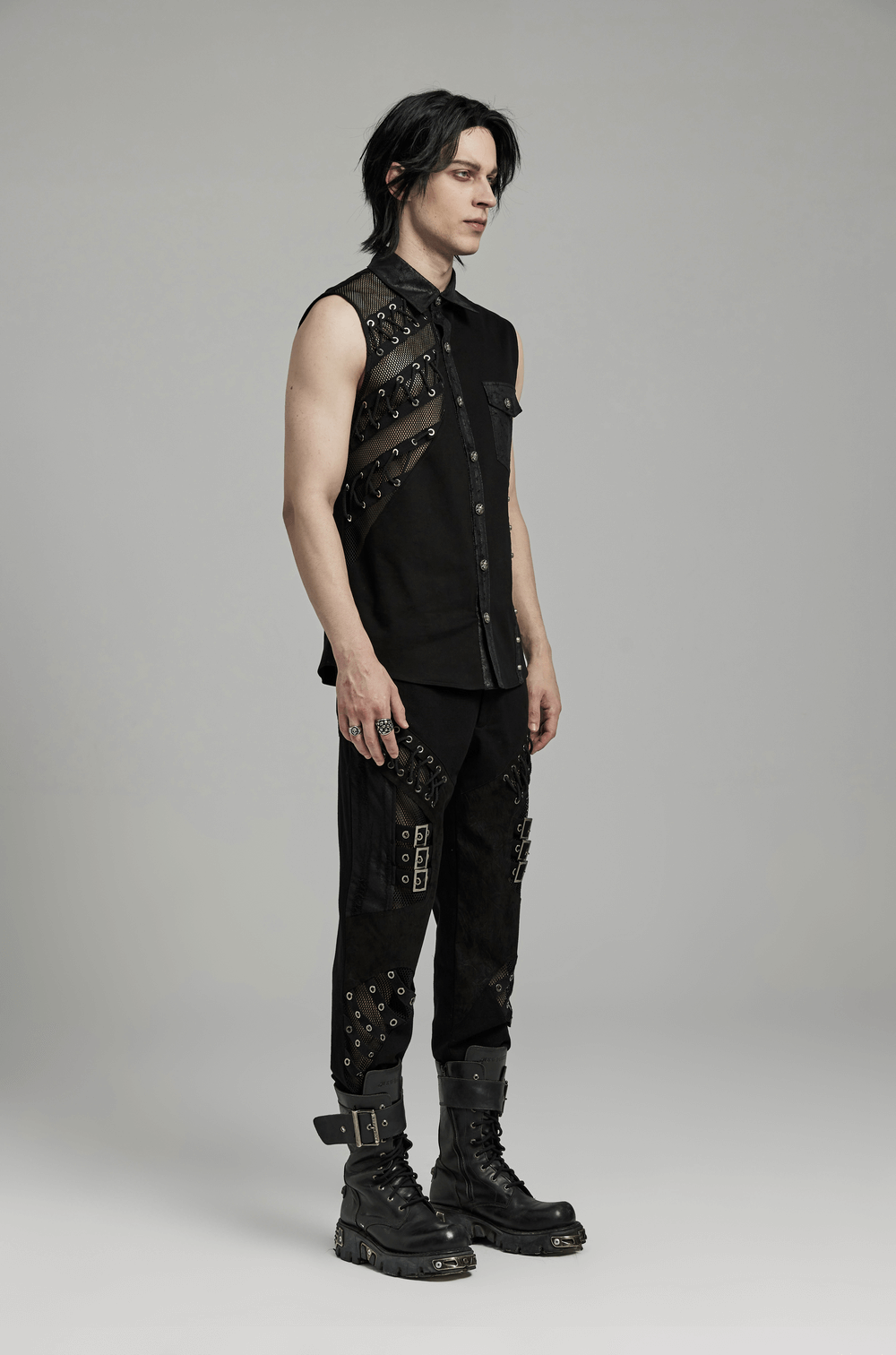 Edgy punk sleeveless asymmetric mesh shirt for men with rivets and eyelets, showcasing a bold urban style.