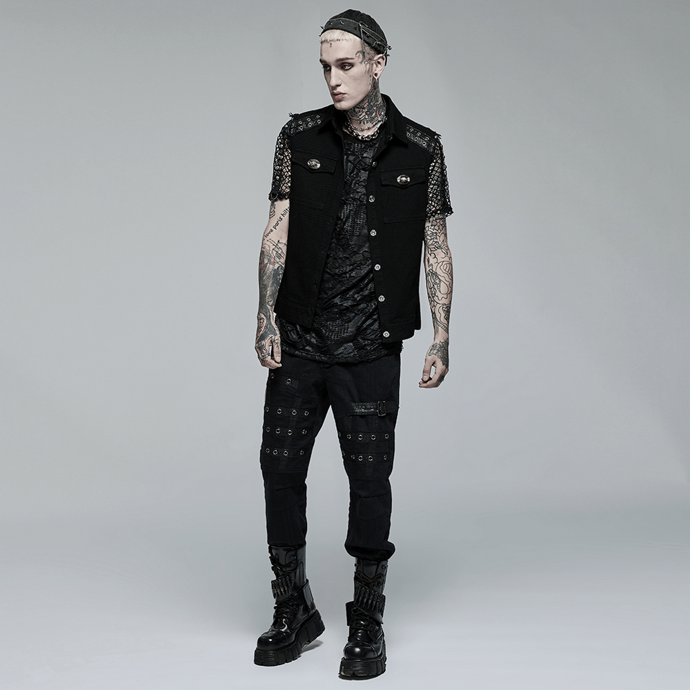 Edgy punk model wearing a sleeveless twill vest with metal accents and stylish black pants.