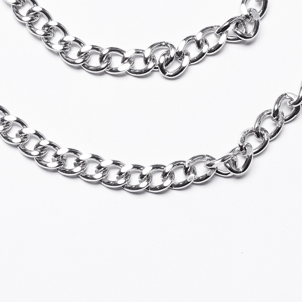 Close-up of a shiny silver chain belt showcasing interlocking links for a bold, edgy style.