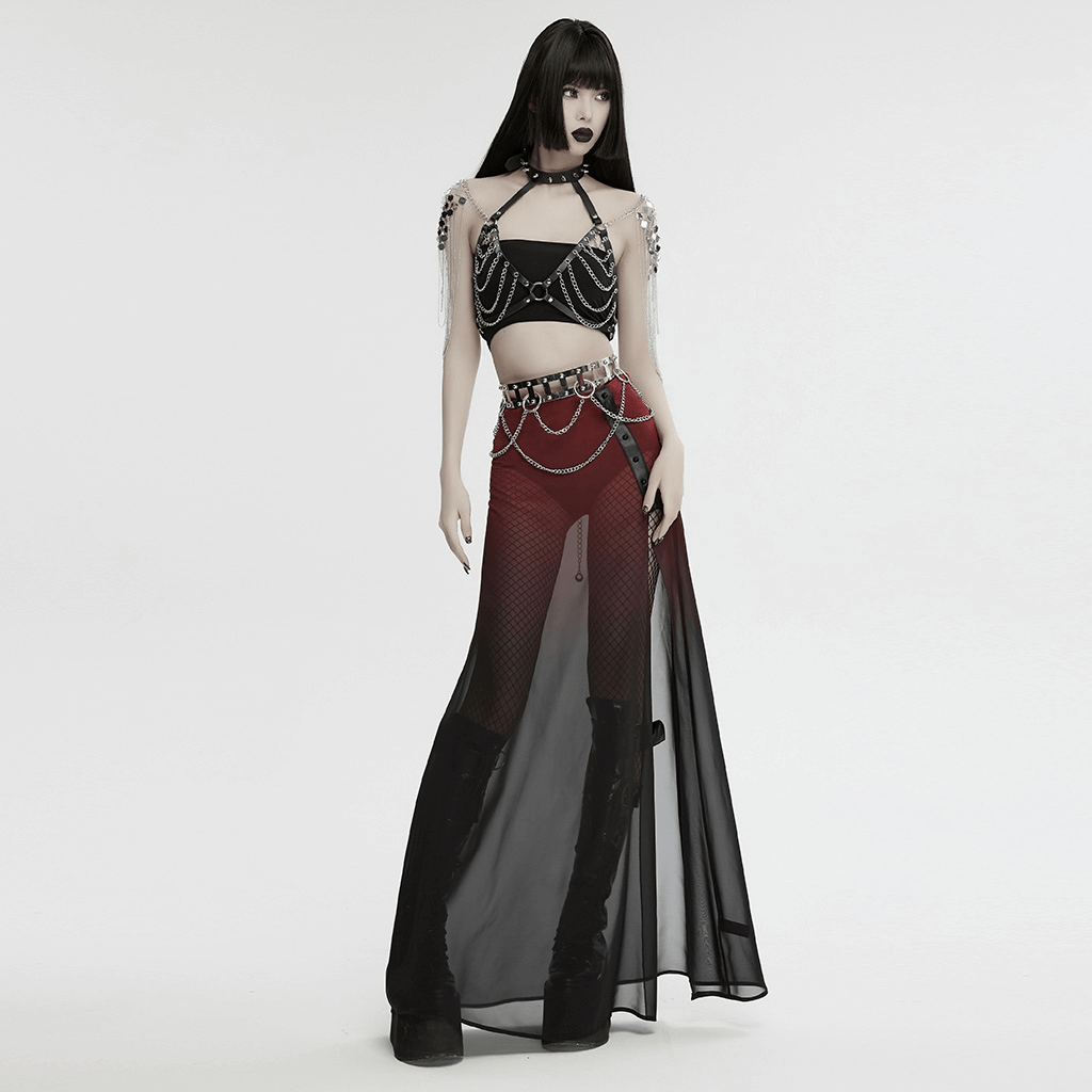 Boldly dressed model in edgy punk outfit featuring a silver chain belt with rivets and sheer black skirt.