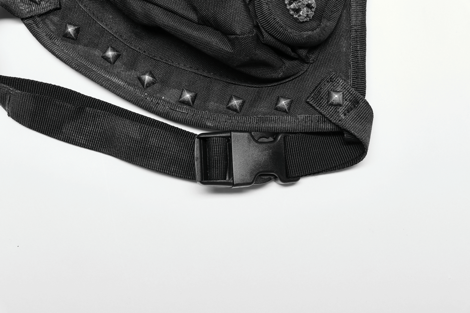 Close-up of adjustable strap and rivets on an edgy punk waist bag, showcasing its unique design and functionality.