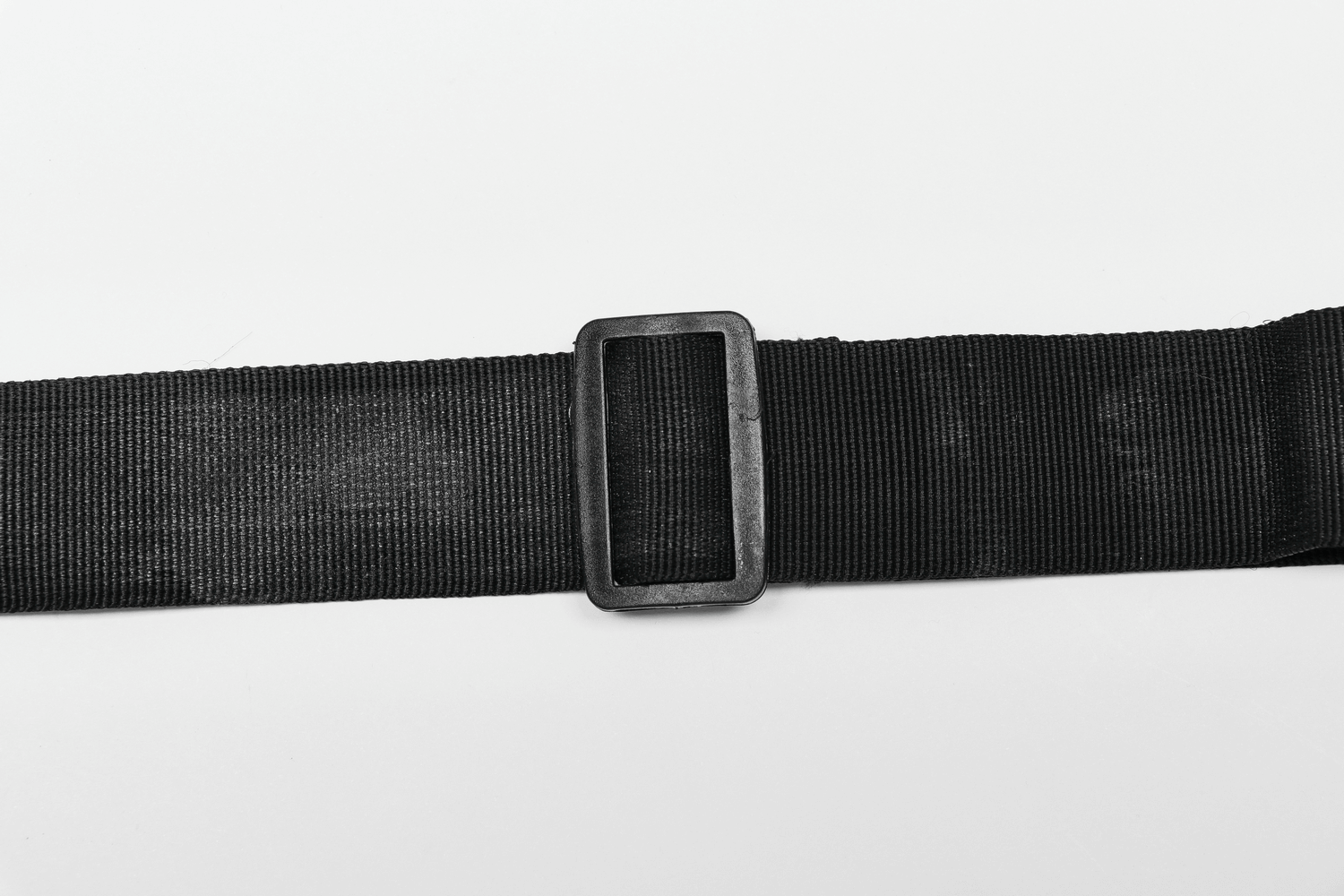 Close-up view of a black nylon webbing strap with a rectangular buckle, perfect for adjustable waist bags.