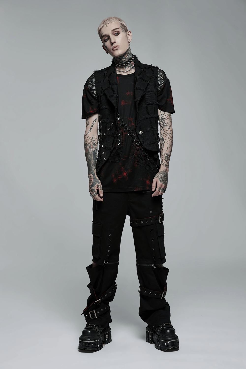 Gothic punk model wearing an edgy wool vest with cut-out back and cargo pants, showcasing bold street style.