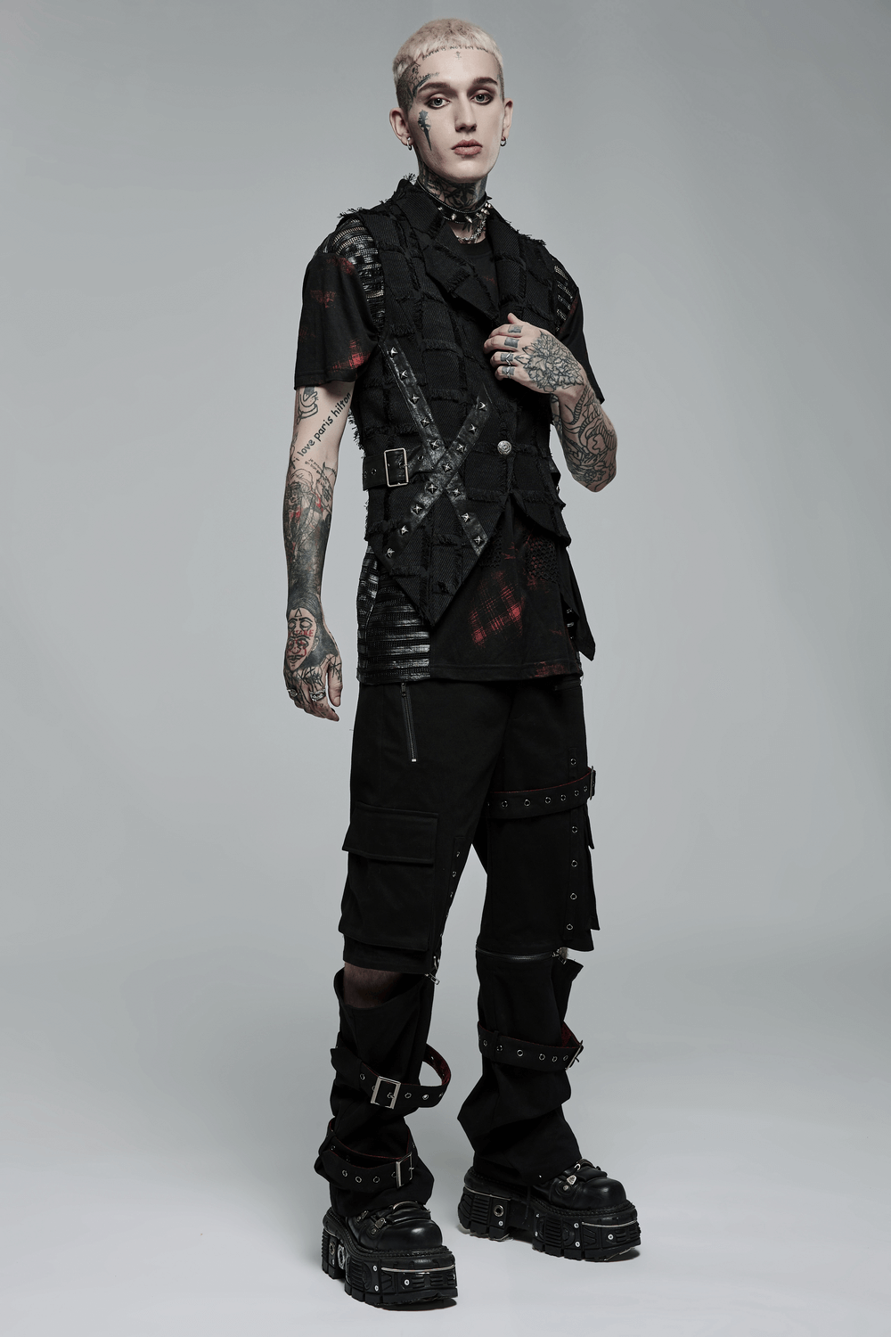 Edgy punk model wearing tailored black wool vest with cut-out back and bold accessories, showcasing unique style.