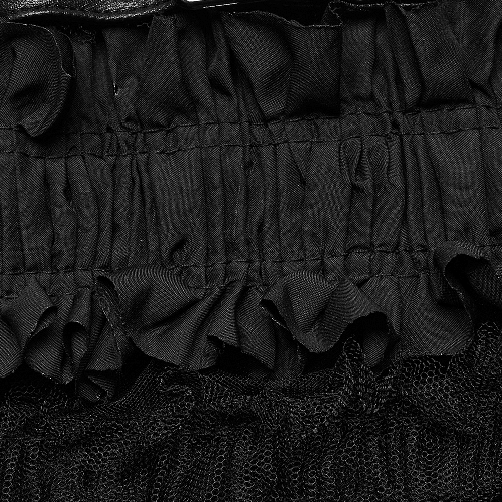 Close-up of edgy ruffled mesh tube top showcasing intricate mesh and woven ruffles in black.
