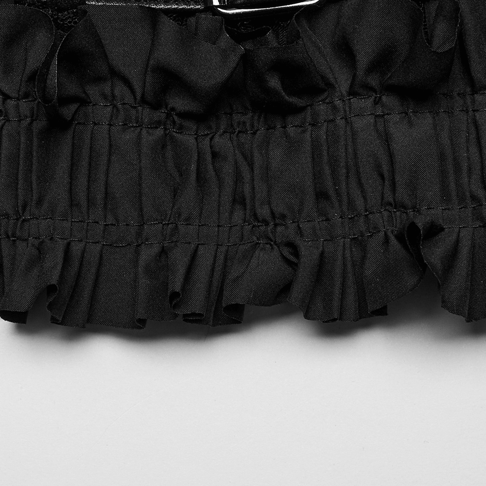 Close-up of black ruffled mesh fabric, showcasing edgy design for punk-style tube top with leather accents.