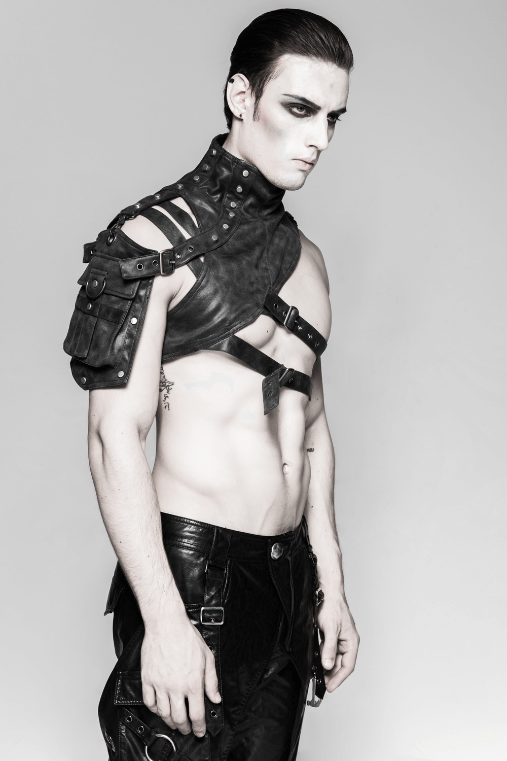 Gothic punk shoulder armor with adjustable buckles modeled by a man in a striking, edgy pose.