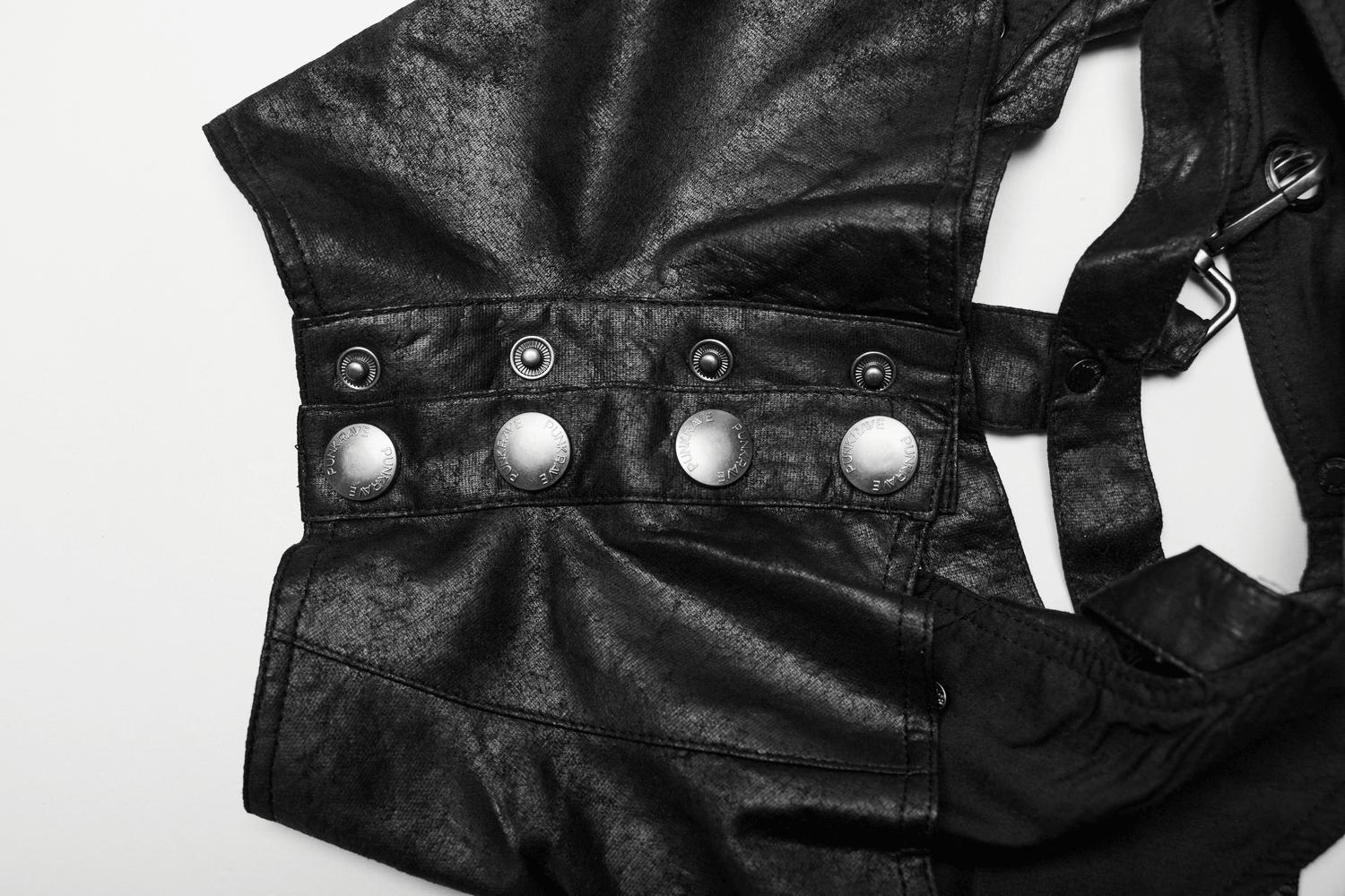 Close-up of gothic punk shoulder armor featuring adjustable straps and stylish metallic buttons.
