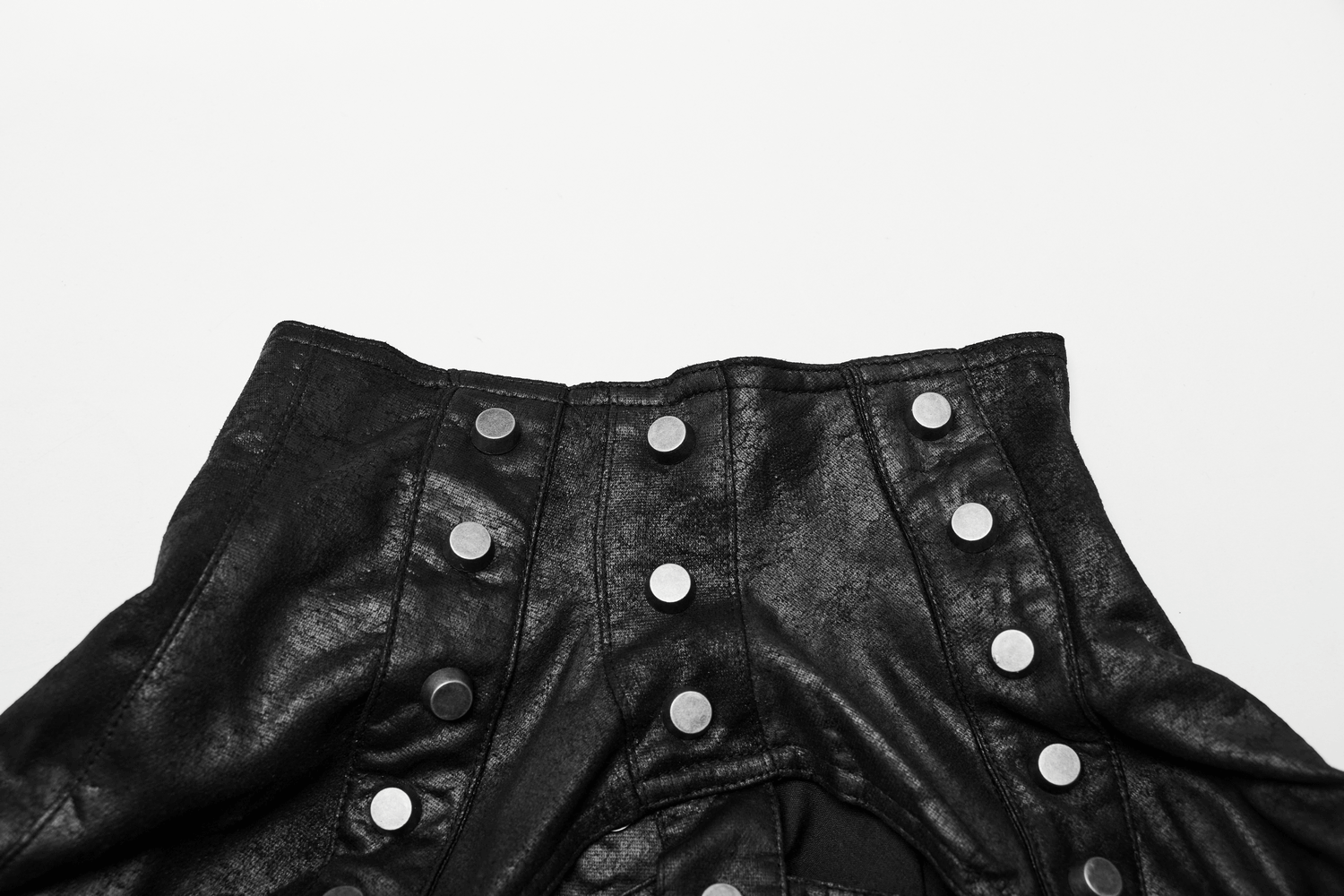 Close-up of black leather shoulder armor with adjustable buckles and stylish silver snaps, ideal for gothic fashion.