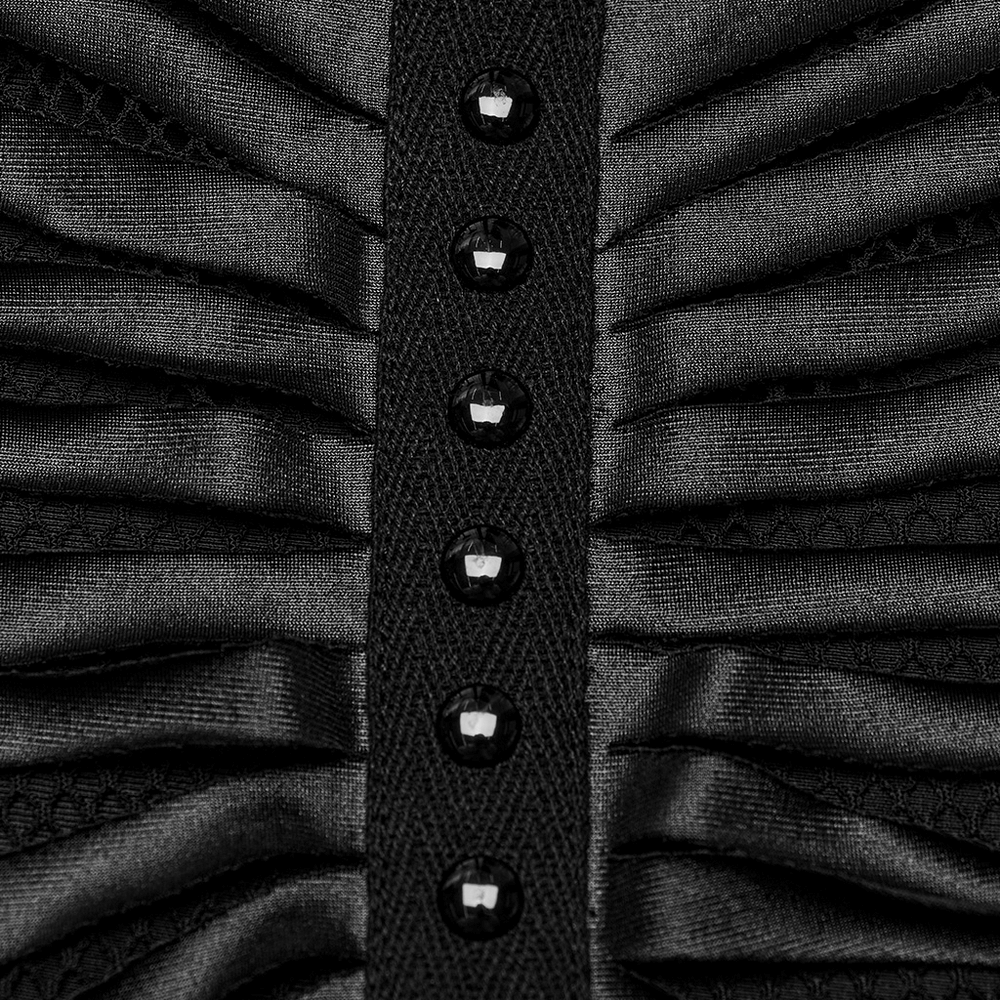 Close-up of black ribbed fabric with decorative buttons and ruching detail for a stylish punk crop top.