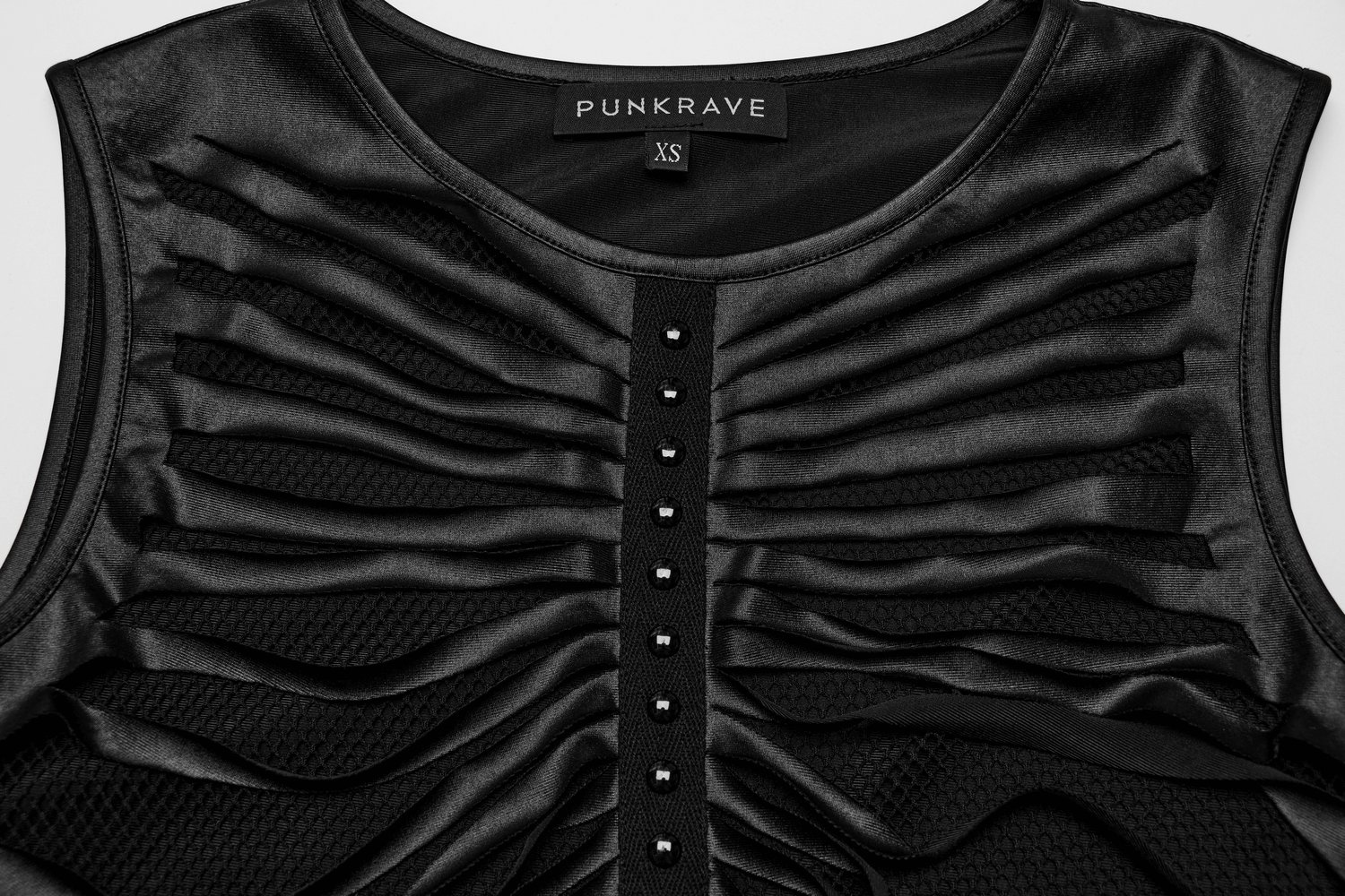 Edgy sleeveless crop top with ribbed design and mesh detail, featuring black fabric and decorative studs.