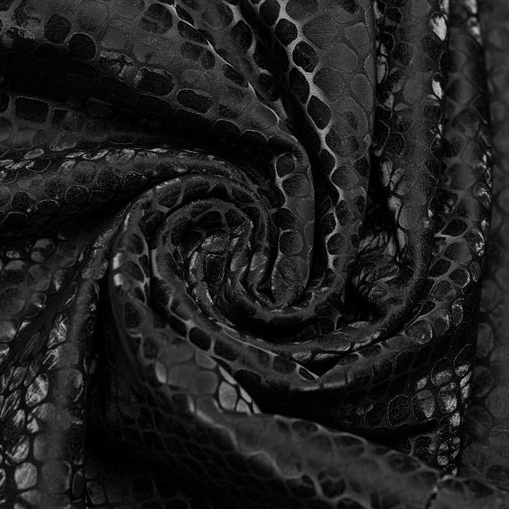 Close-up of edgy black snake-skin patterned fabric, perfect for a punk sleeveless dress.