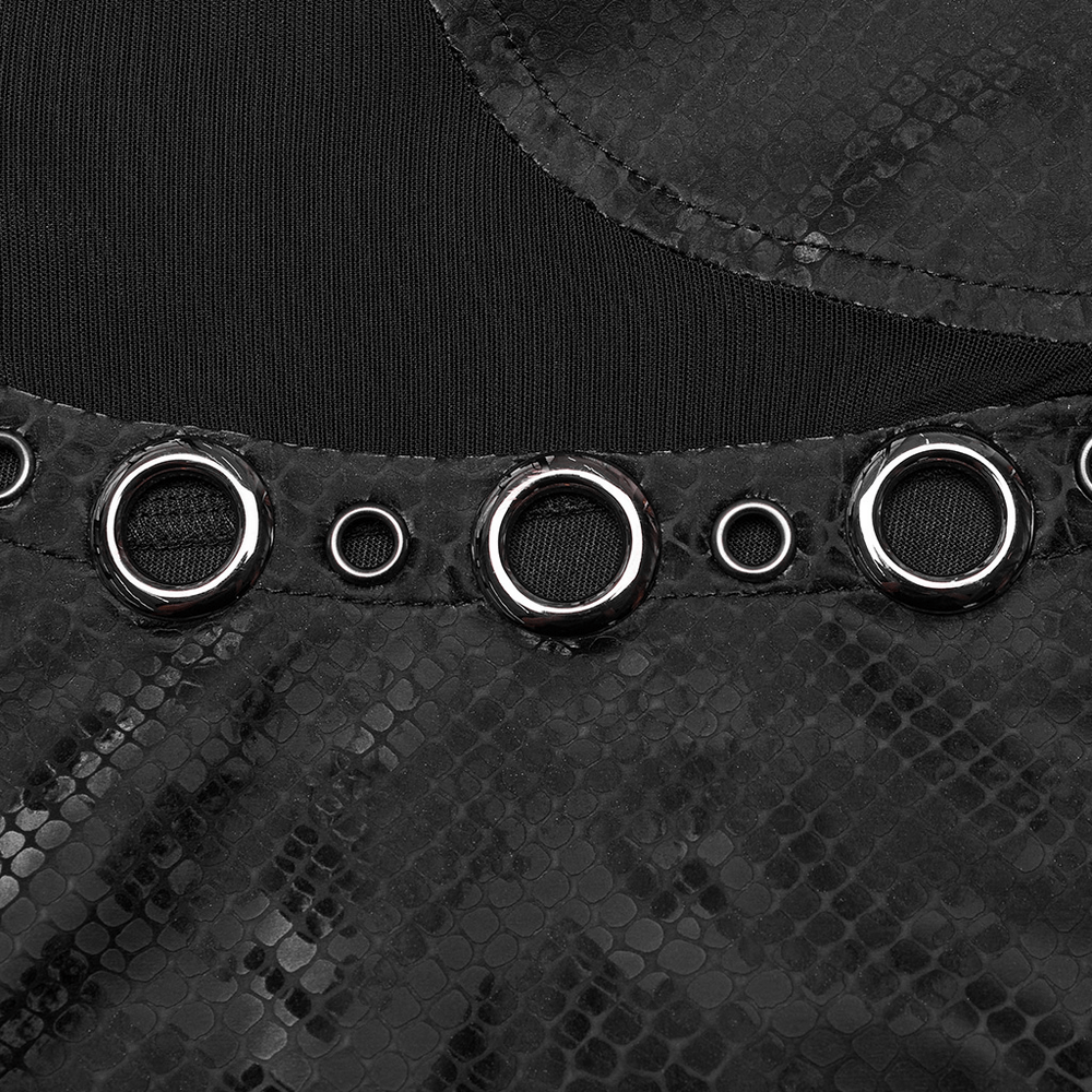 Close-up of edgy snake-skin patterned punk dress featuring large metal eyelets and textured fabric.