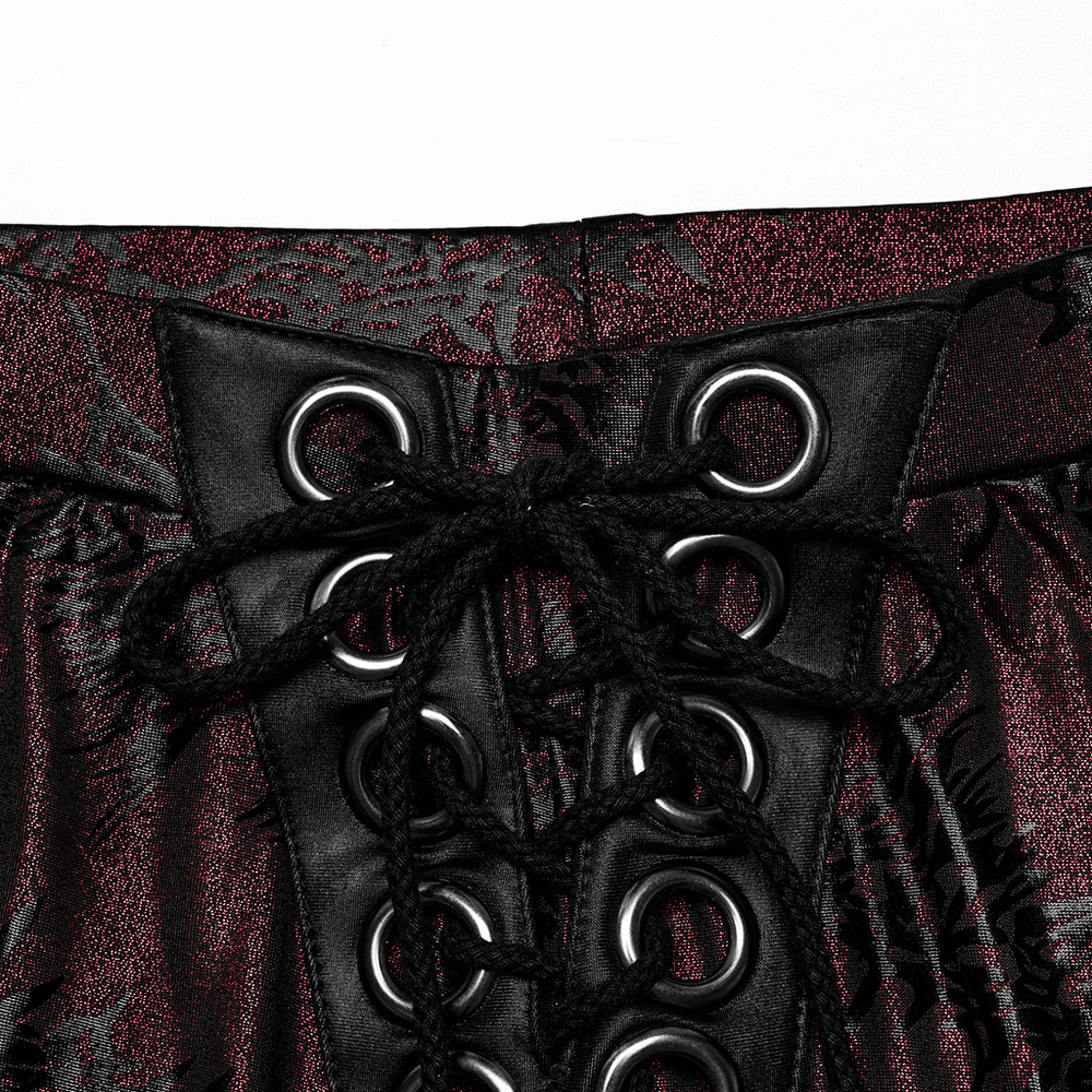 Close-up of edgy lace-up detail on sparkly flared pants for women, showcasing dramatic black and red texture.