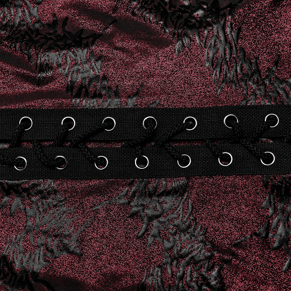 Close-up of edgy sparkly flared pants with lace-up detail and dramatic texture in dark burgundy.