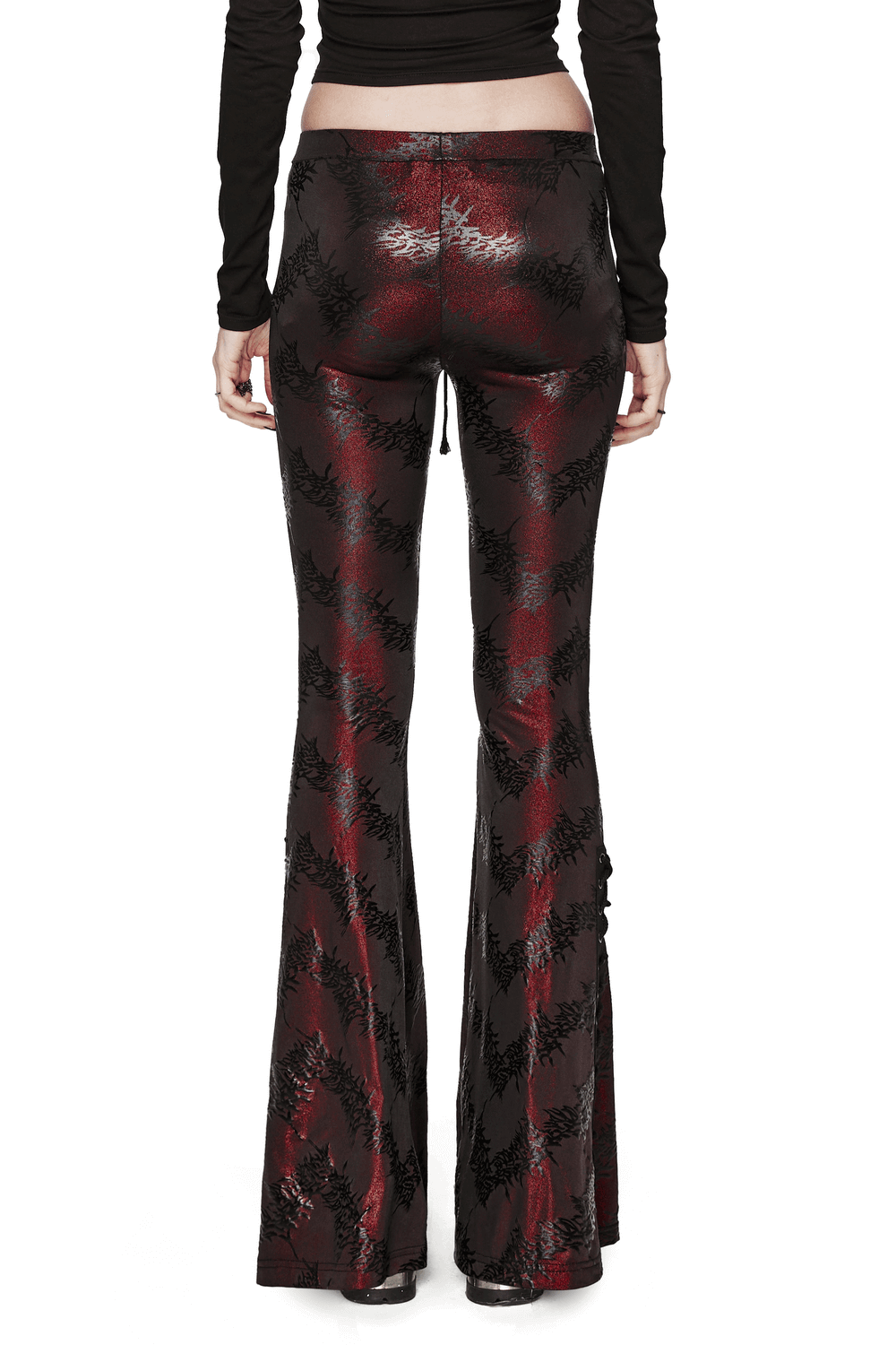 Edgy sparkly flared pants with lace-up detail, showcasing dramatic silhouette and unique tree texture pattern.