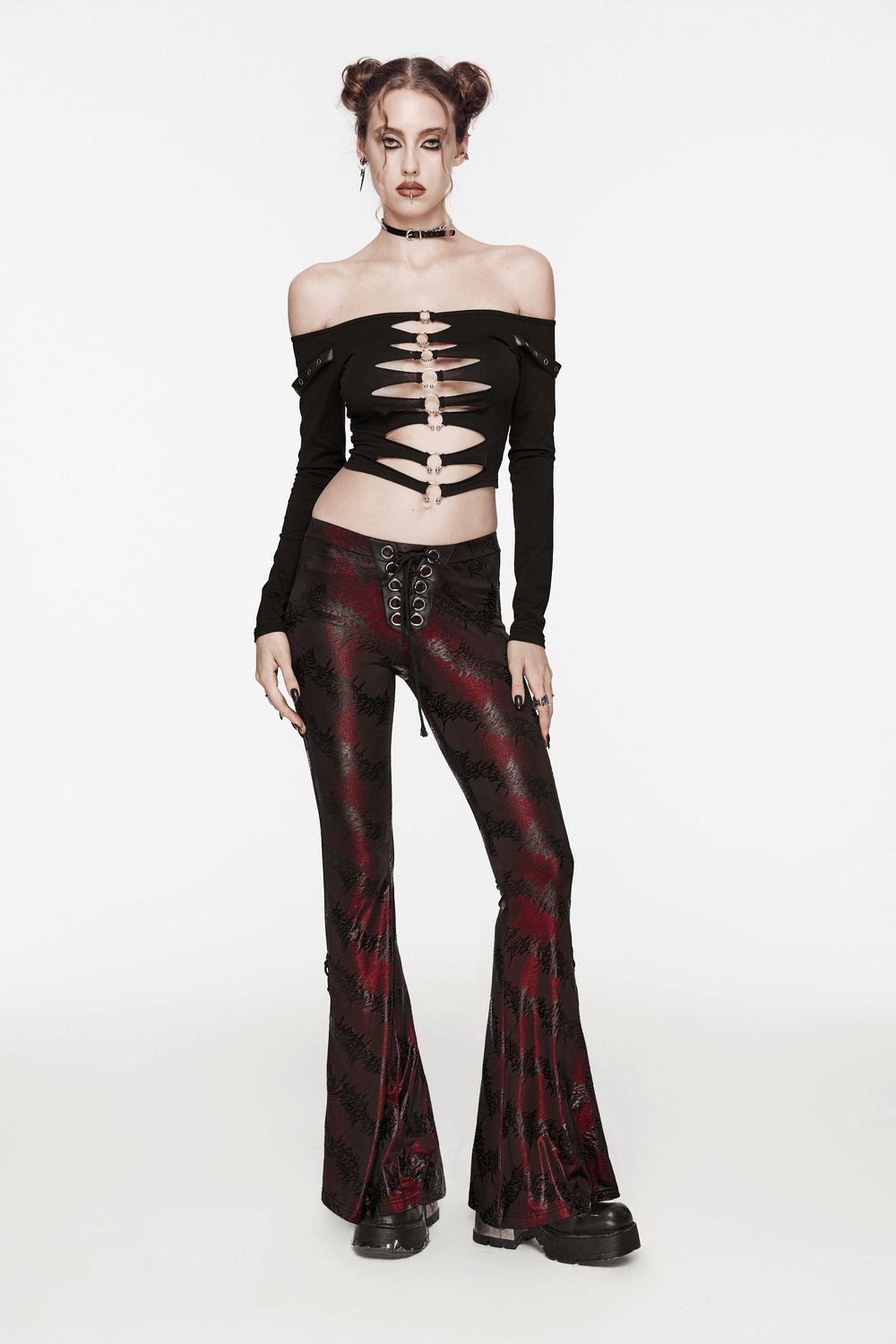 Edgy sparkly flared pants with lace-up detail, styled with an off-shoulder top for a dramatic fashion statement.