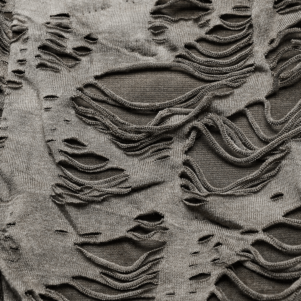 Close-up of edgy tie-dye slip dress fabric showcasing distressed, tattered texture and intricately woven knit details.