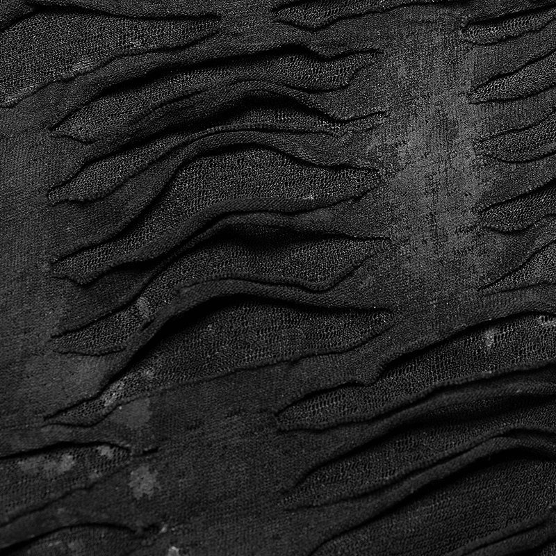 Close-up of textured black fabric with dramatic lace-up details, showcasing an edgy design.