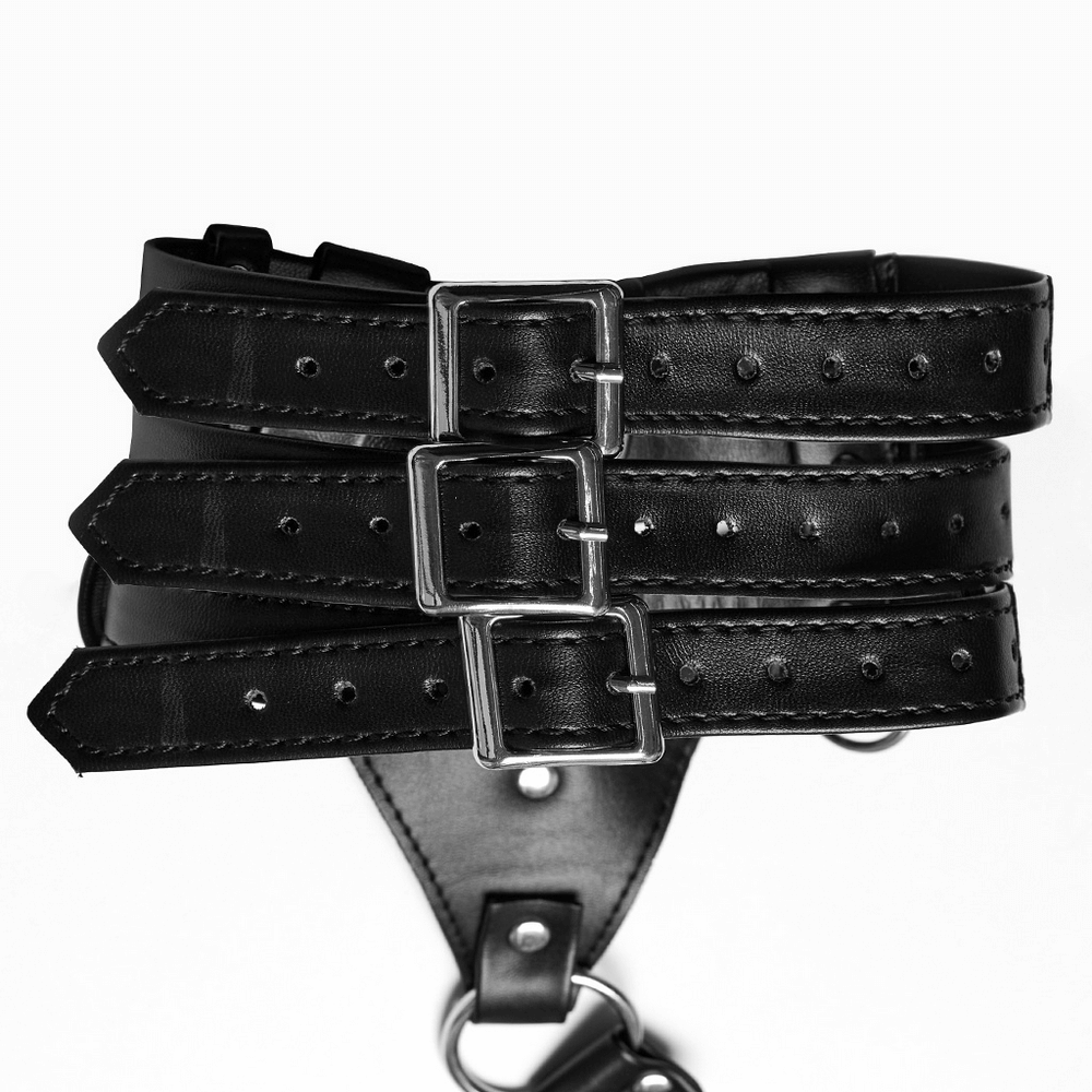 Close-up of edgy black PU leather body harness showing adjustable straps and silver buckles.
