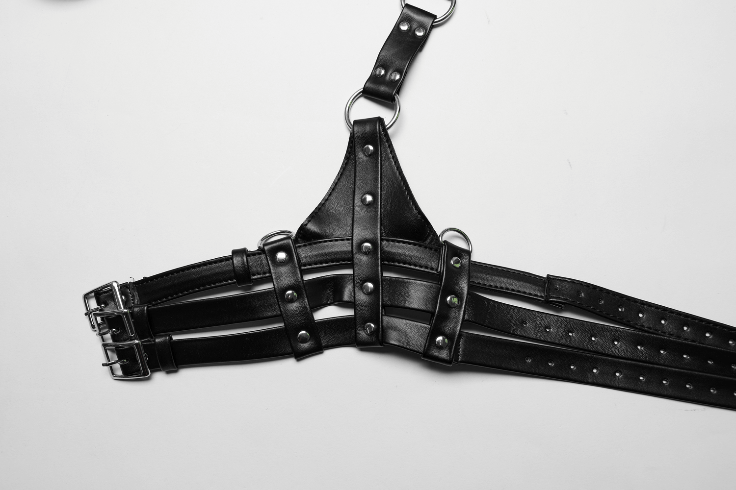 Edgy black PU leather body harness with adjustable straps and metal loop for a bold look.