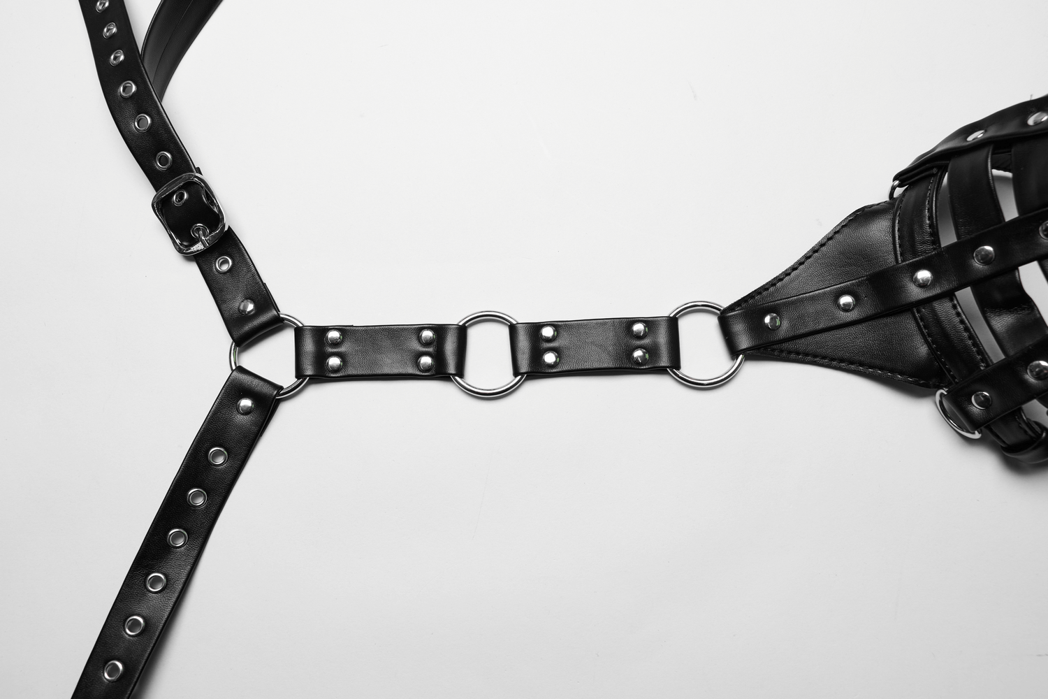 Edgy women's PU leather body harness featuring bold rings and a striking design for a punk-inspired look.