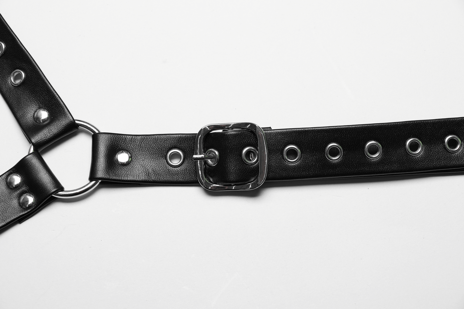 Edgy black PU leather body harness with adjustable buckle and metal studs, perfect for punk fashion enthusiasts.