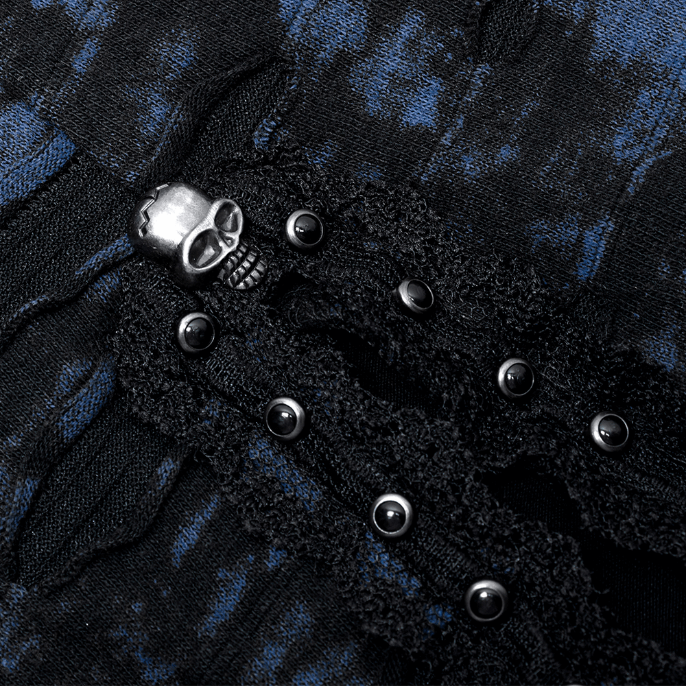Close-up of a Gothic abstract print dress showcasing lace details and skull accents in dark blue and black.