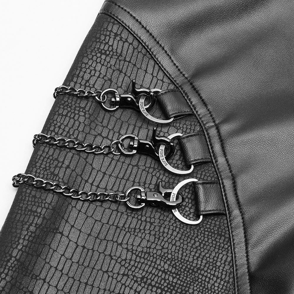 Close-up of elastic crackle PU leather leggings with detachable chains and punk rock details.