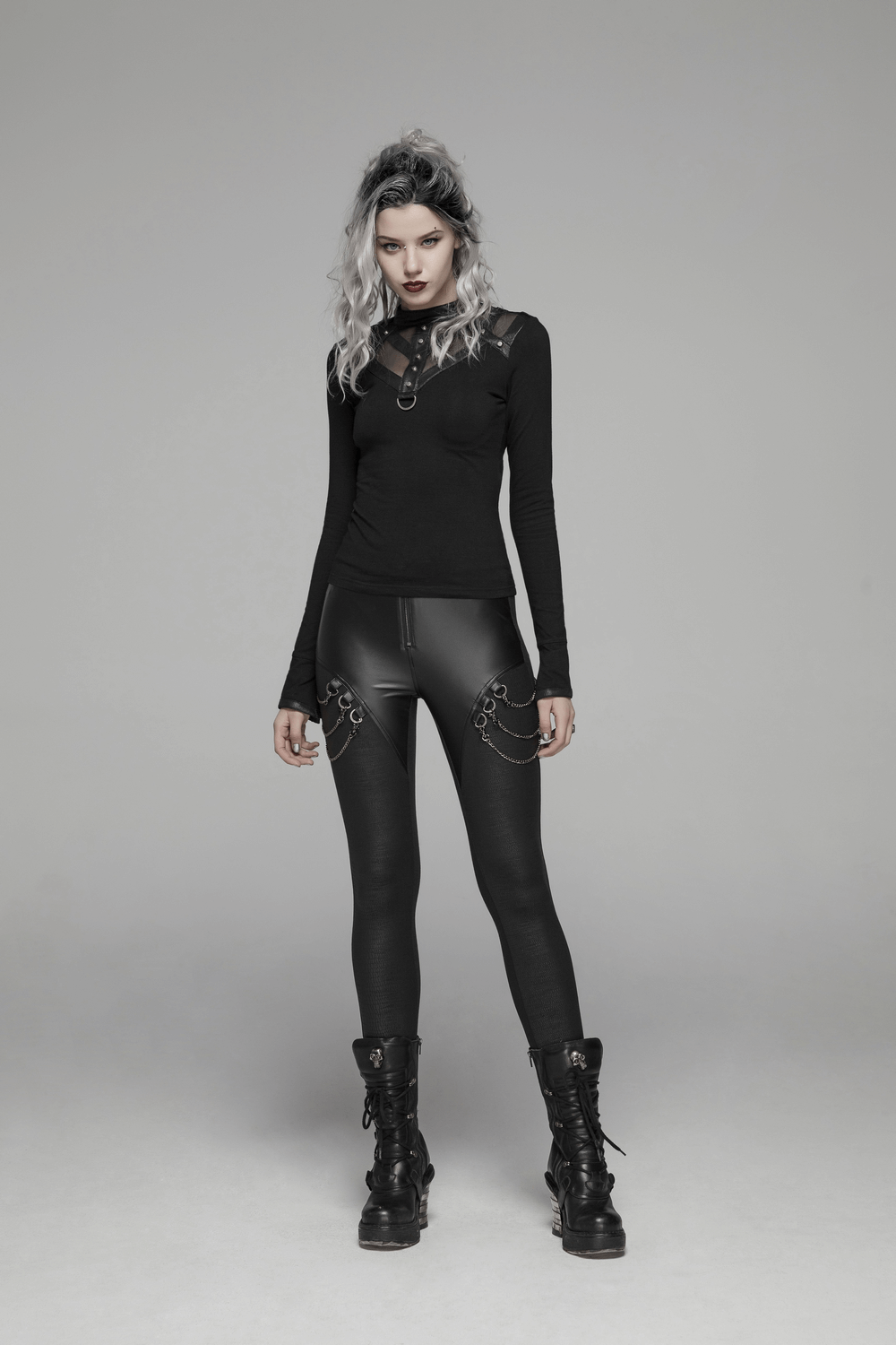 Model in high-waisted crackle PU leather punk rock leggings with chain detail, showcasing edgy fashion vibes.
