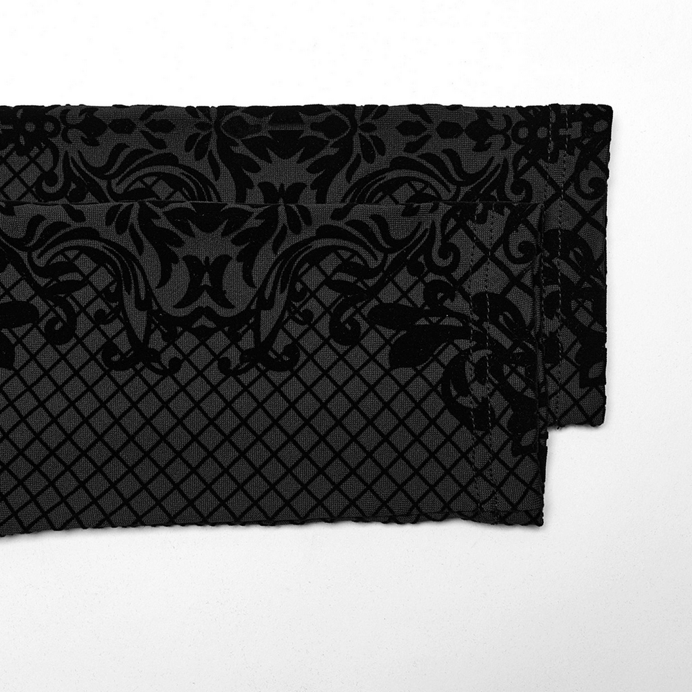Close-up of black elastic knit fabric featuring a gothic flocking pattern and high-collar design for alternative fashion.