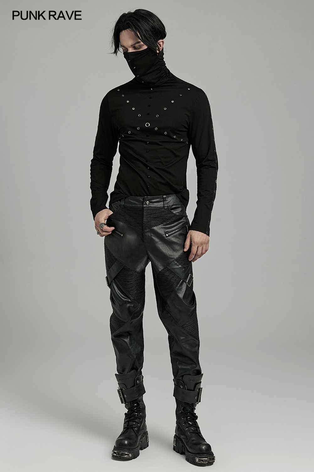 Men's edgy punk style outfit featuring leather pants with zippers and a stylish black top.