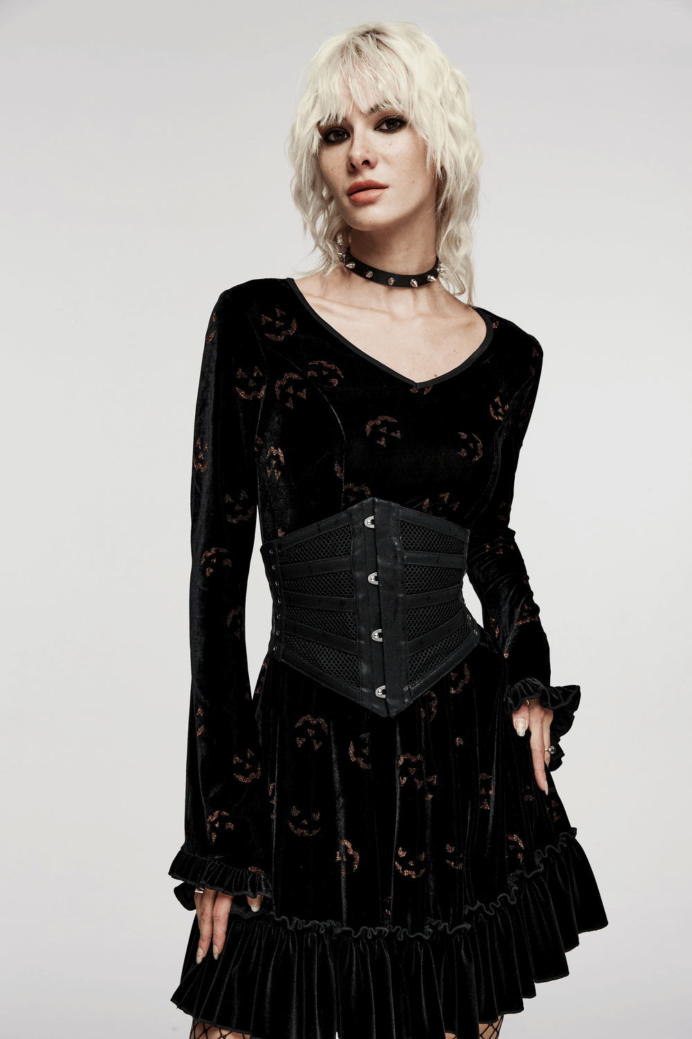 Model showcasing the Elastic Mesh Punk Corset Belt with steel buckle details over a stylish black dress.