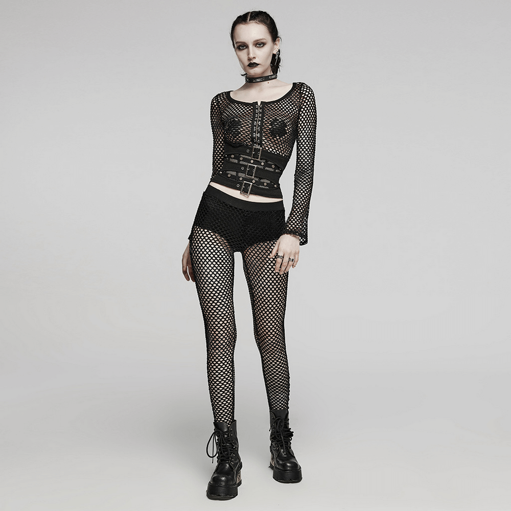 Edgy woman in black fishnet leggings, matching mesh top, and combat boots, showcasing stylish punk rock fashion.