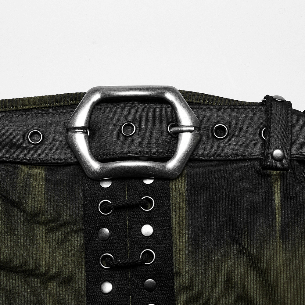 Close-up of a sleek silver buckle on a fashionable black and green ribbed fabric dress.