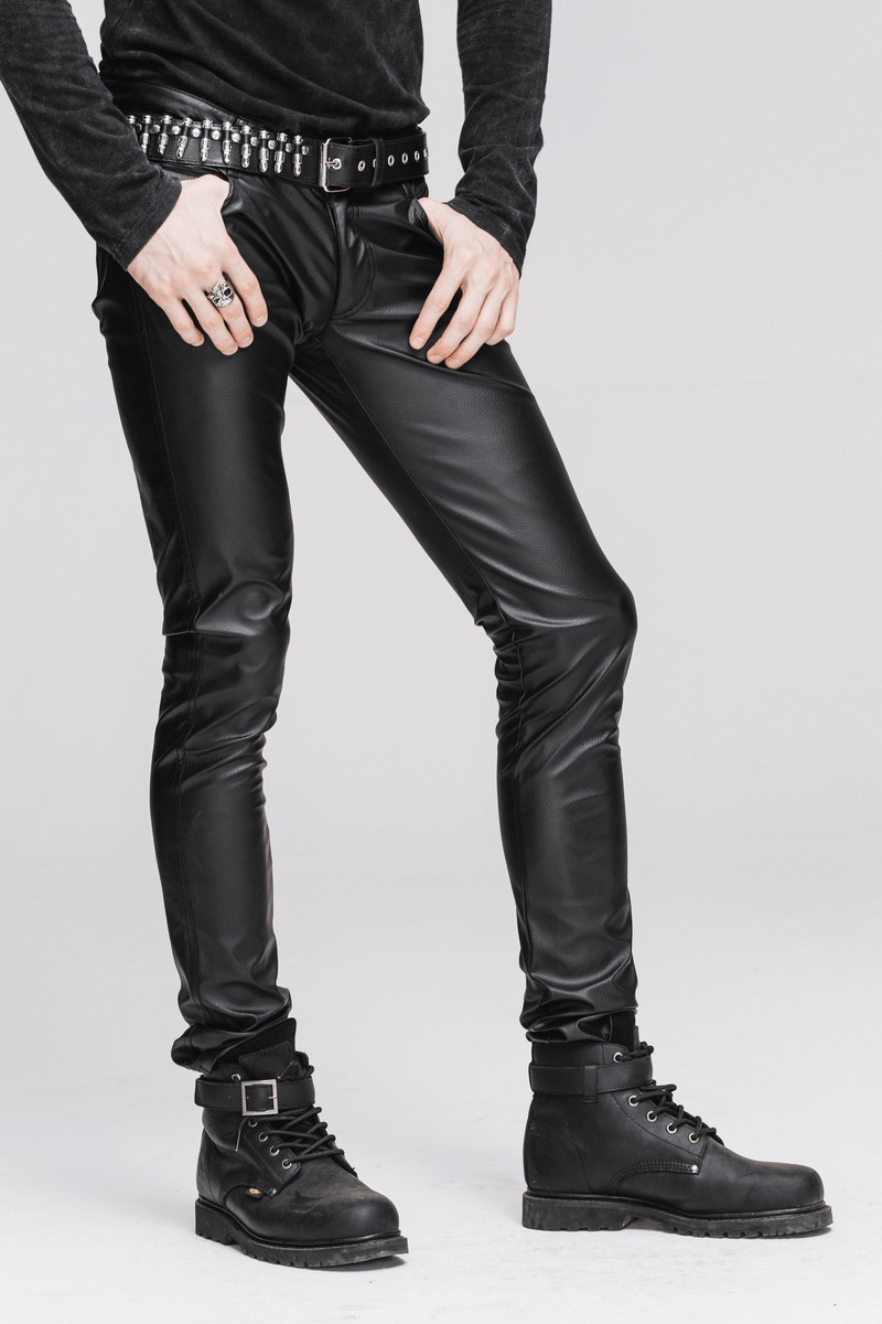 Men's black PU leather skinny pants in punk style with studded belt and stylish black boots.