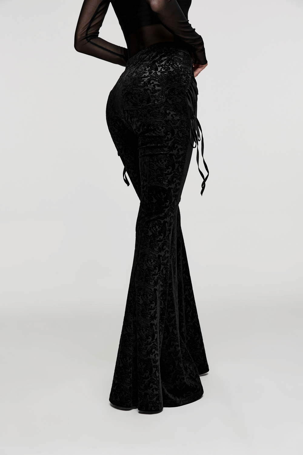 Elastic velvet gothic flare pants with side lacing showcasing dark jacquard texture and stylish fit.
