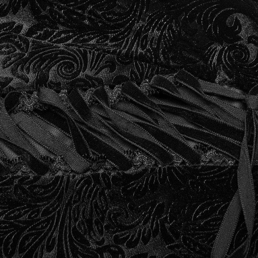 Close-up of black embossed velvet with lace-up detailing, showcasing gothic texture and elegant design.