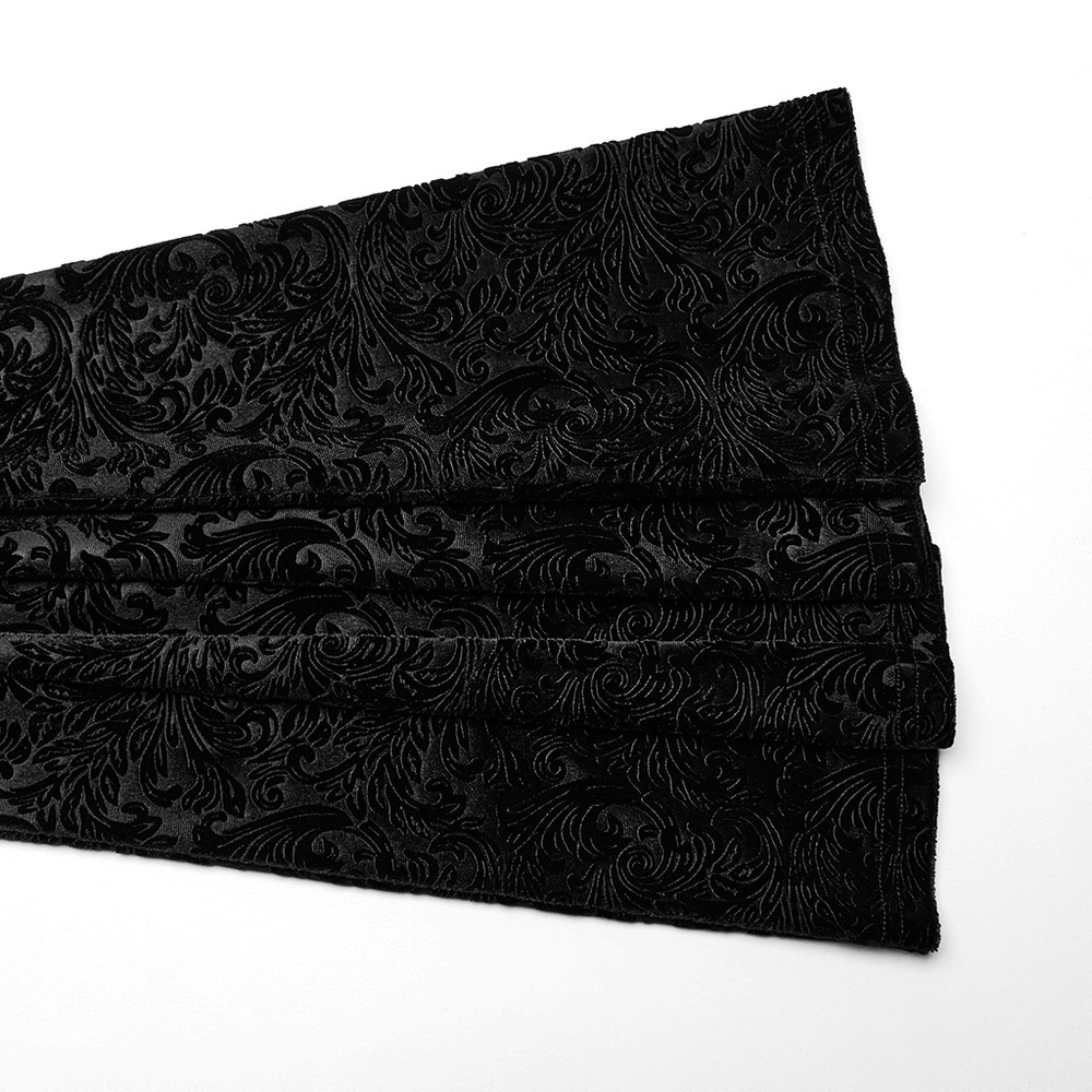 Embossed black velvet fabric with intricate floral patterns, perfect for gothic flare pants.