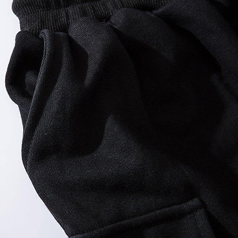 Close-up of elastic waistband on black men's joggers with a soft, comfortable fabric texture.
