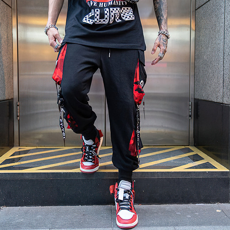 Men's elastic waist joggers with multiple pockets and stylish straps, perfect for casual streetwear outfits.