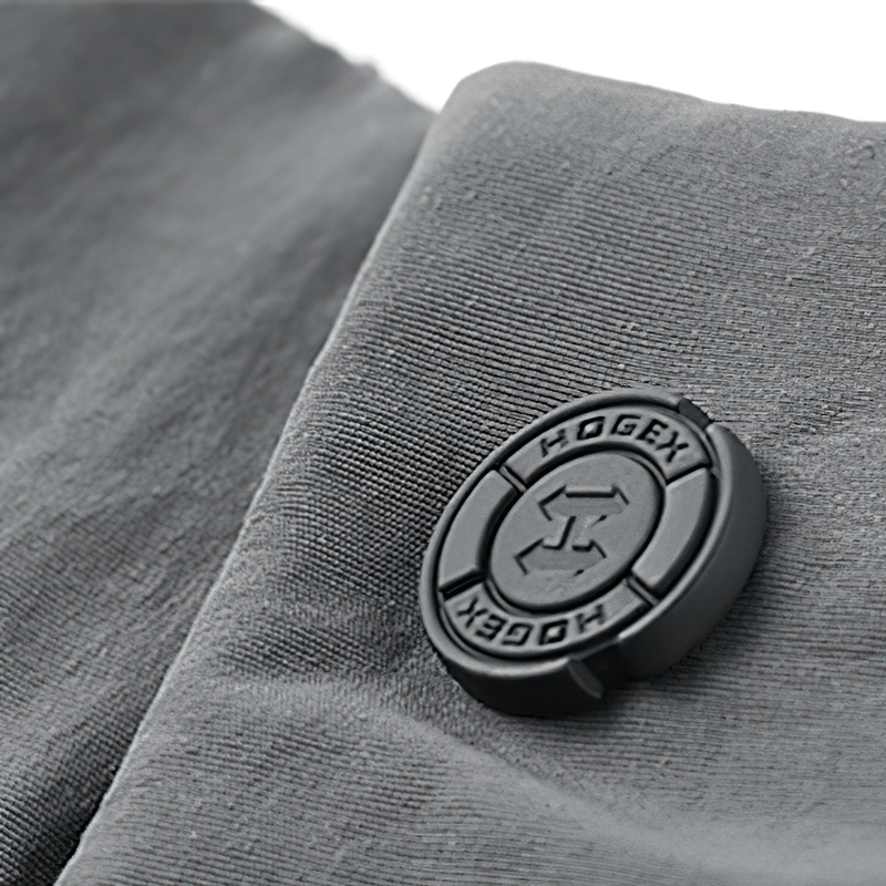 Close-up of tactical shorts fabric with HOGEX logo button, showcasing quality and design.