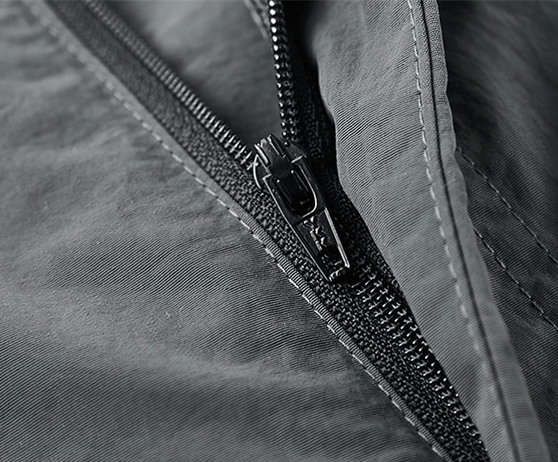 Close-up of a sleek black zipper on stylish tactical shorts, emphasizing functionality and design.